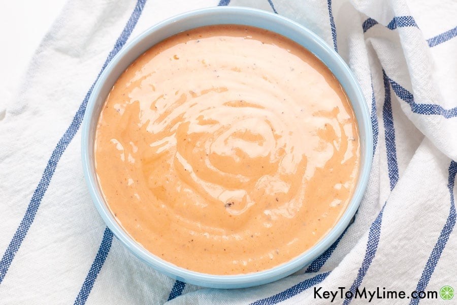 A small blue bowl filled with homemade chicken dipping sauce.