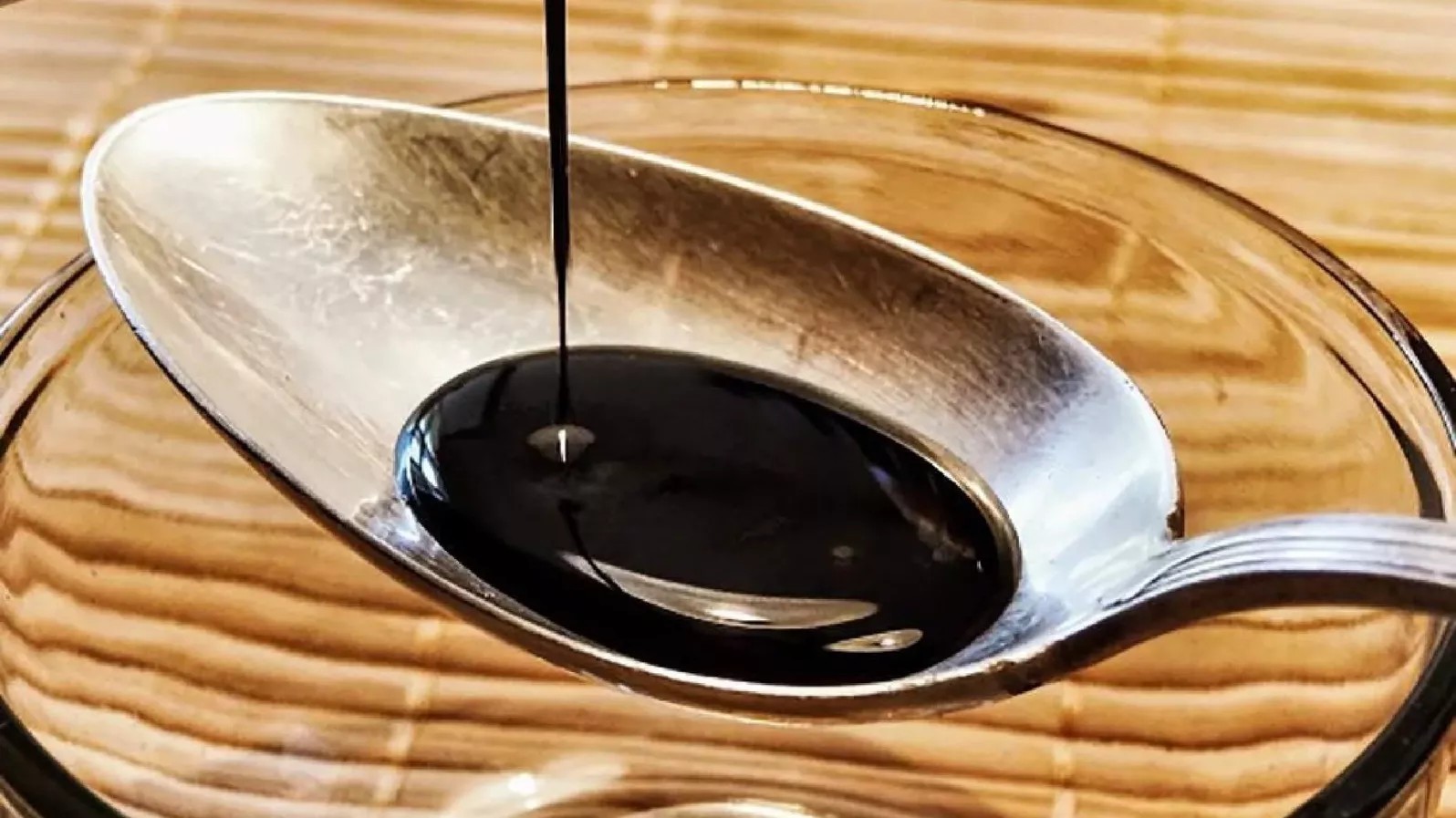 Indonesian sweet soy sauce (kecap manis) in a bottle, showcasing its dark color and thick consistency.