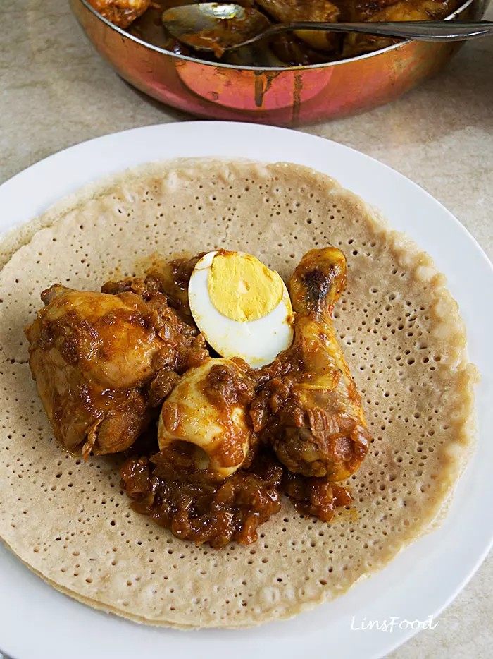 Injera batter being poured onto a griddle