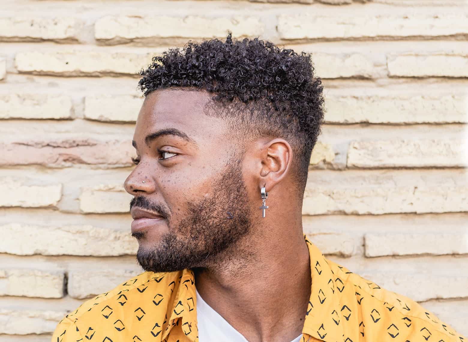 Visual representation of a drop fade haircut, showing the fade descending behind the ear for a unique, curved appearance