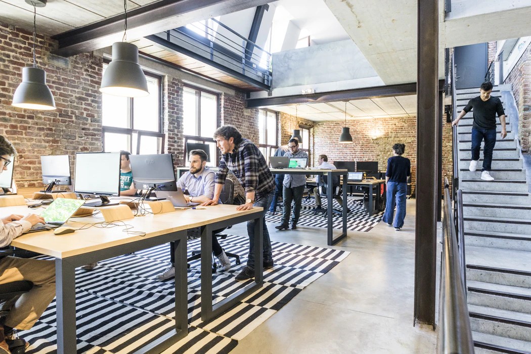 Entrepreneurs collaborating at a shared workspace, emphasizing teamwork and innovation