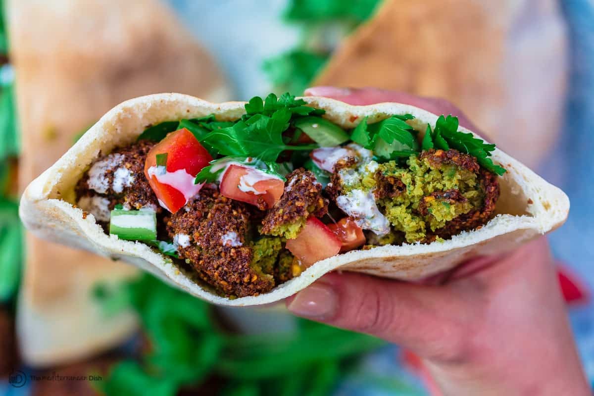 Falafel served in pita bread with tahini sauce and salad