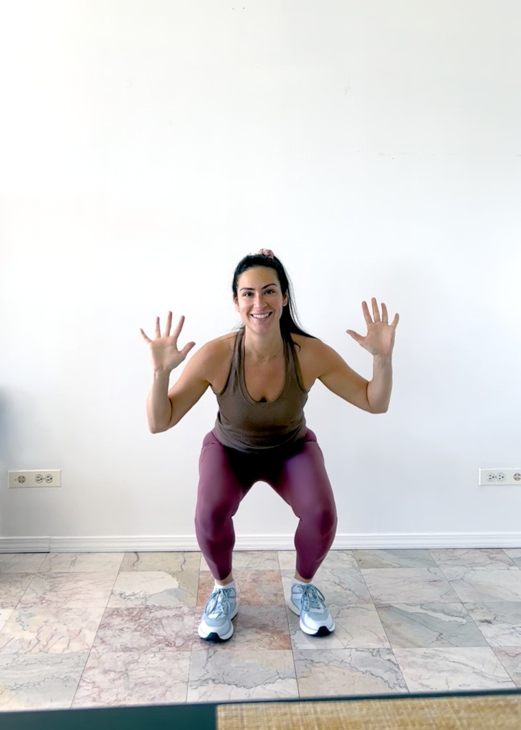 Woman performing a squat jump as a tabata exercise