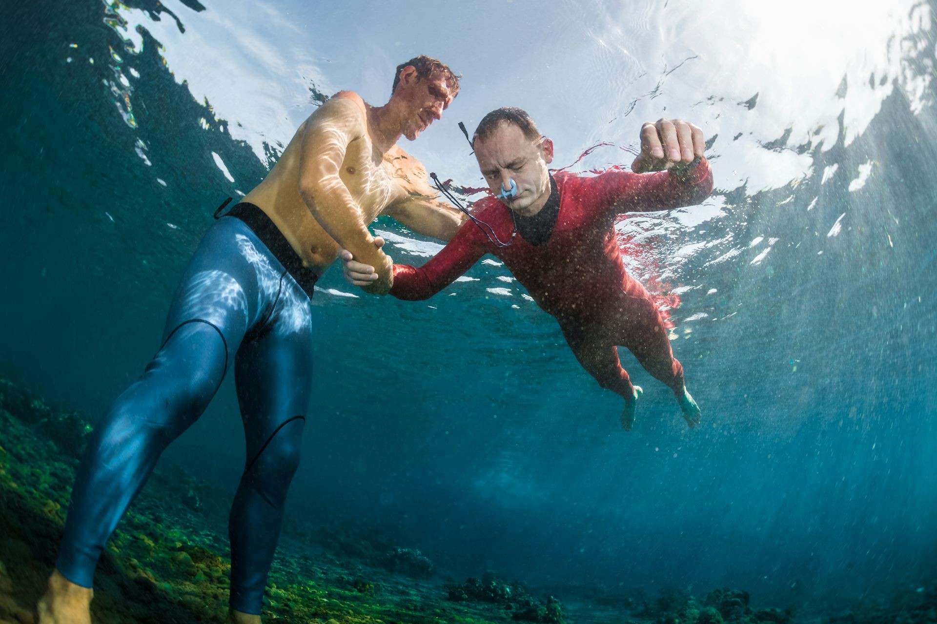 Freedivers ascending along a guide rope.