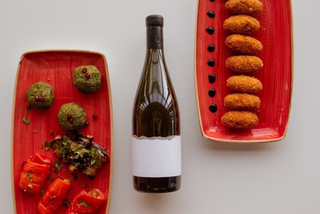 People learning about what is sake around a bottle and food