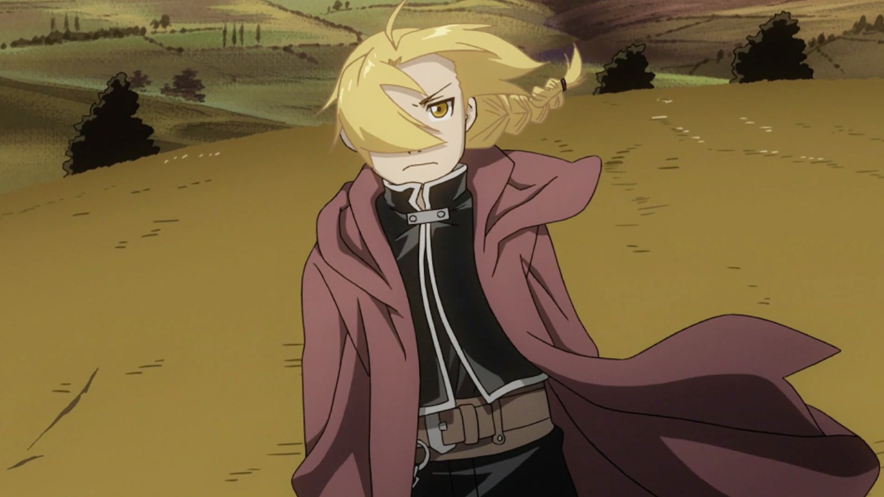 A blond-haired person in a long coat
