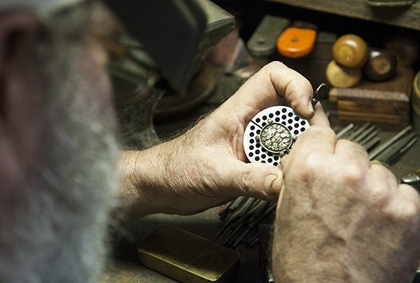Tom Patterson working on a green man motif on a silver brooch