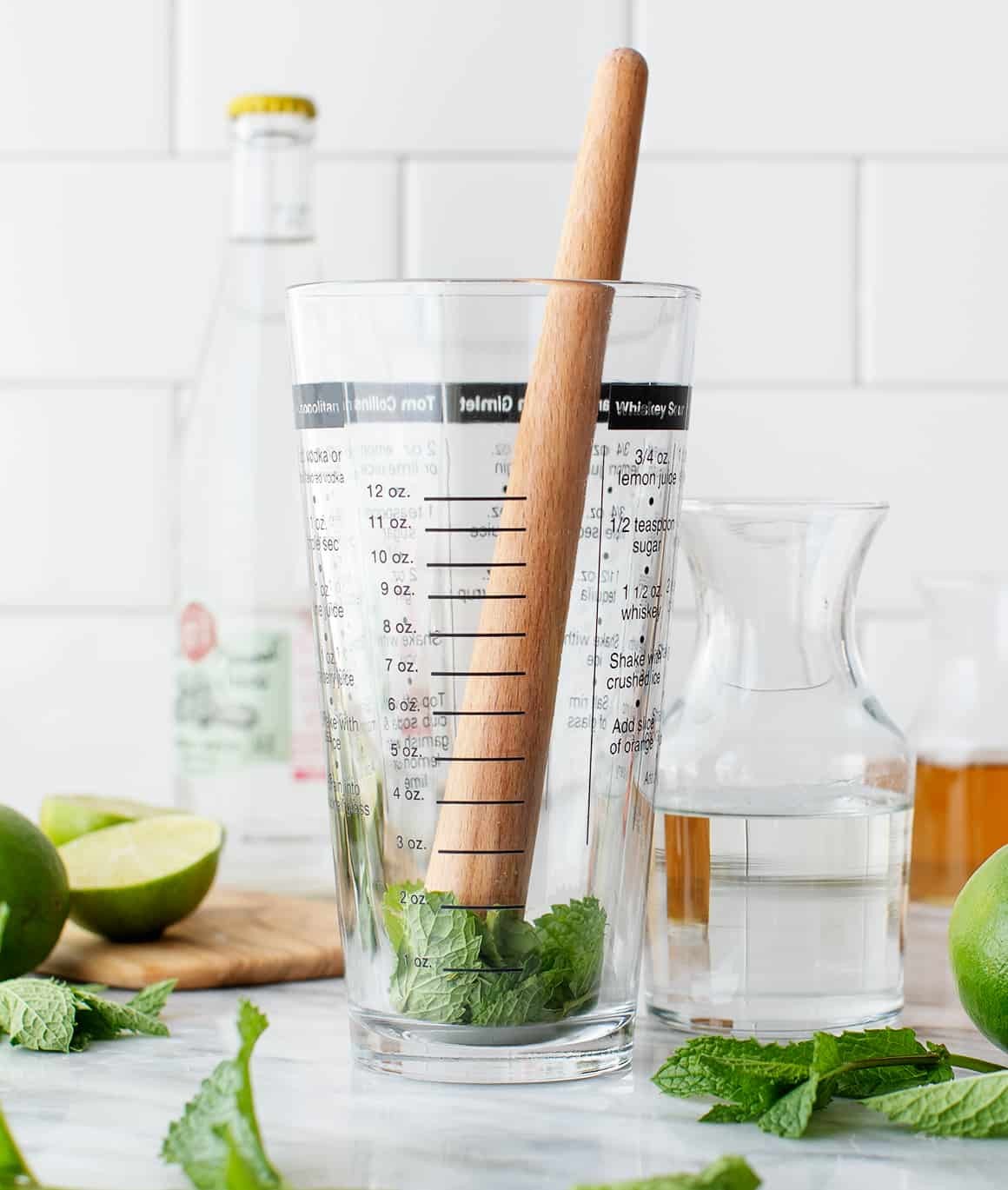Muddling mint in a glass