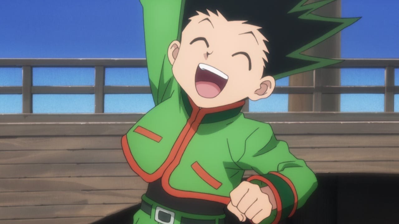 A boy jumps punches his hand in the air with glee