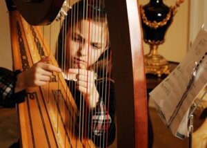 A young harpist performing with grace