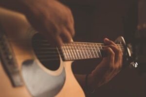 A guitarist playing a chord