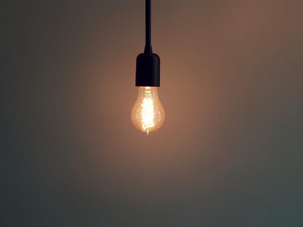 Close-up of an incandescent bulb showing the glowing filament