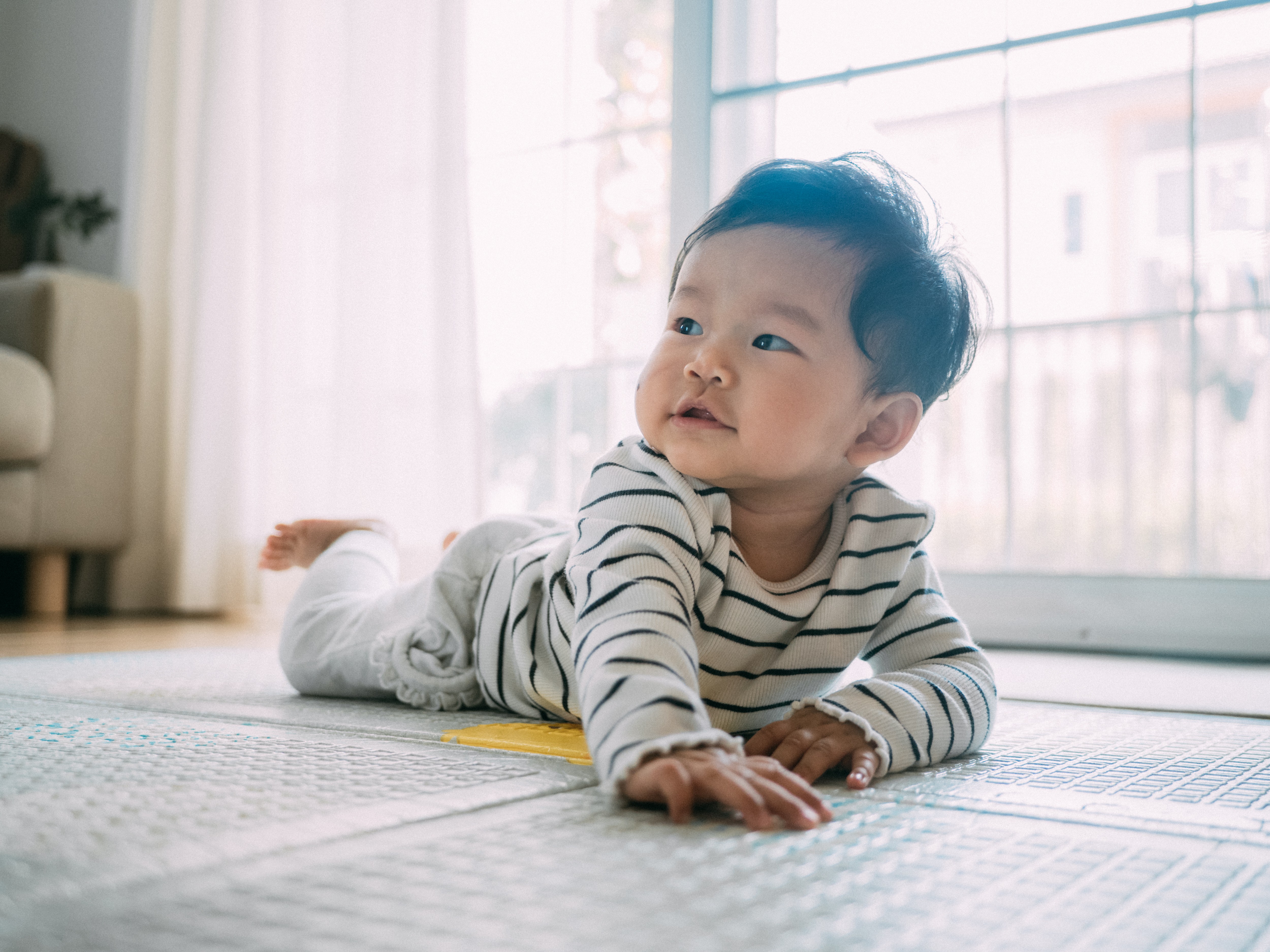 Mother and baby doing push ups together to encourage crawling