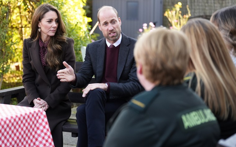 Prince William, Prince of Wales and Catherine, Princess of Wales speak with members of the Emergency Services during a visit to Southport Community Centre.