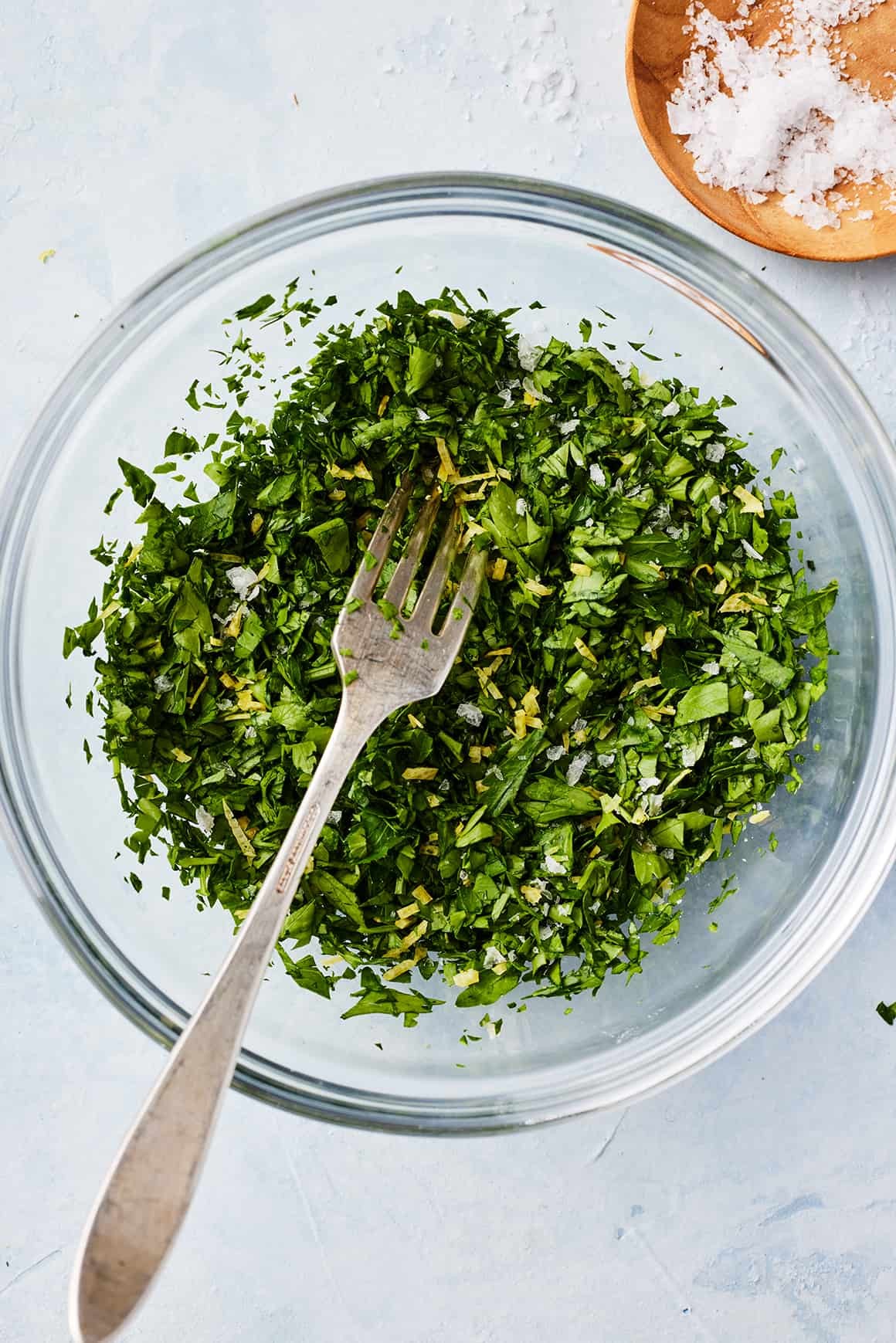 Gremolata in small glass bowl with fork