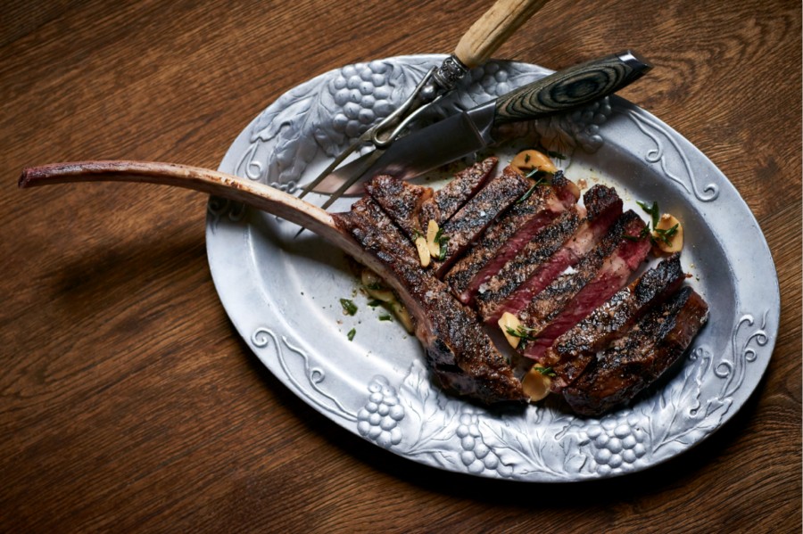 A tomahawk steak from Maple & Ash Chicago, representing Chicago's upscale steakhouse scene