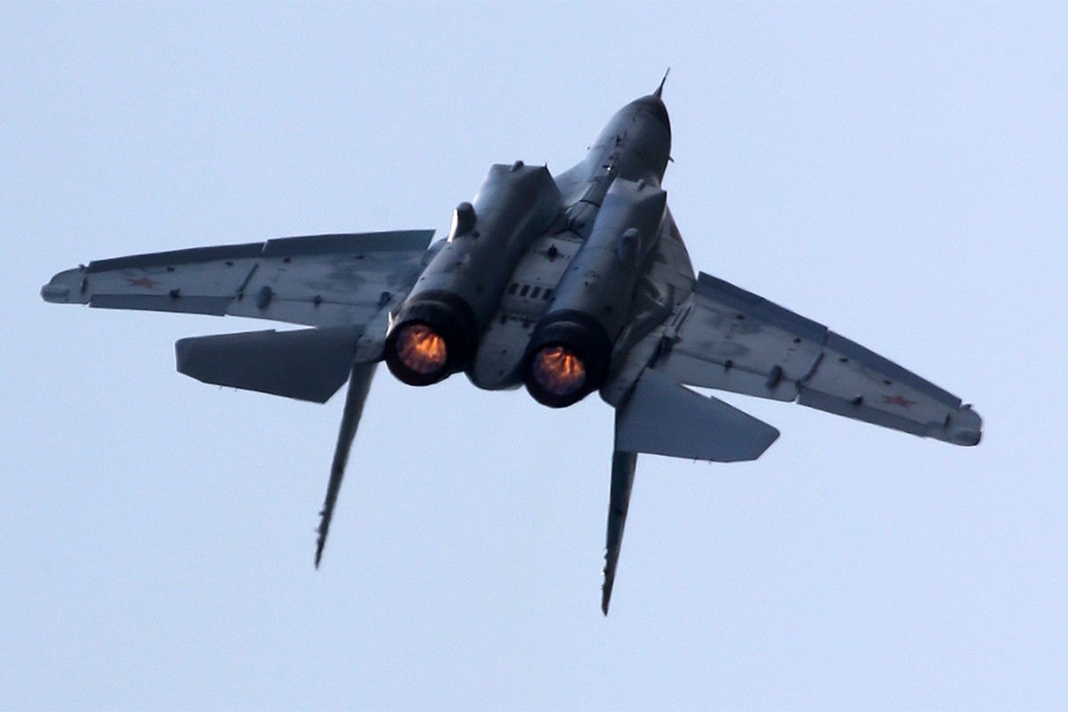 Fighter jet flying upside-down, displaying the aerial capabilities of the MiG-31 at the MAKS-2021 International Aviation and Space Salon in Zhukovskiy, Russia