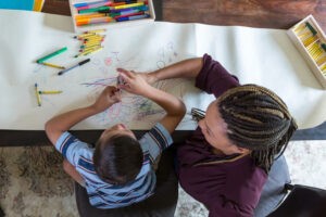 RBT working with a child on a coloring activity