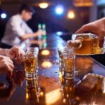 pouring whiskey into shot glass