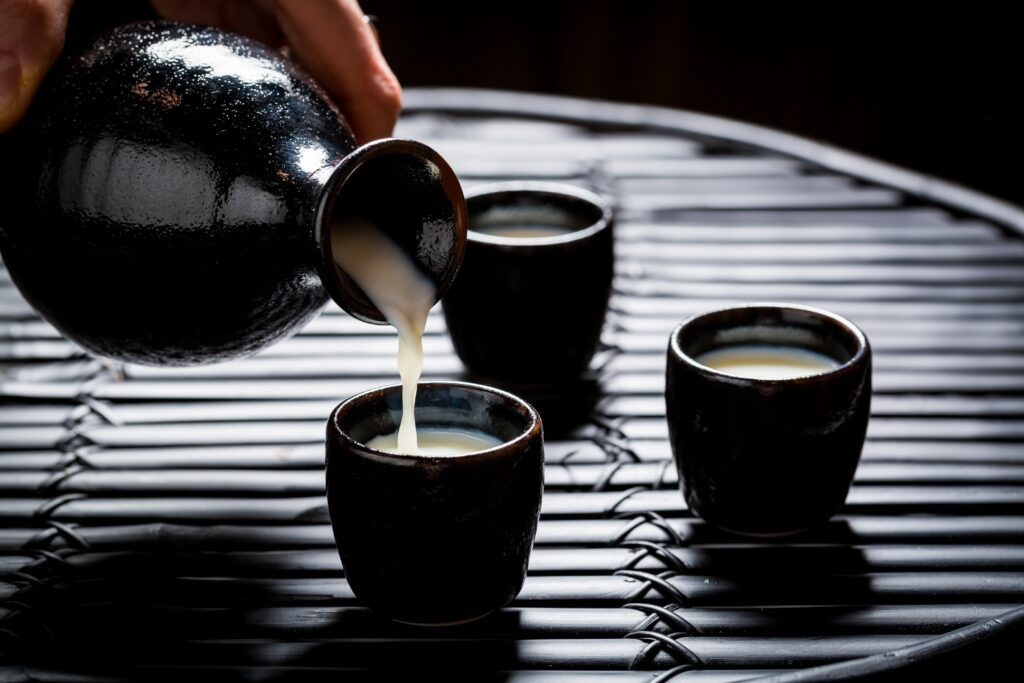 Person pouring while explaining What is sake