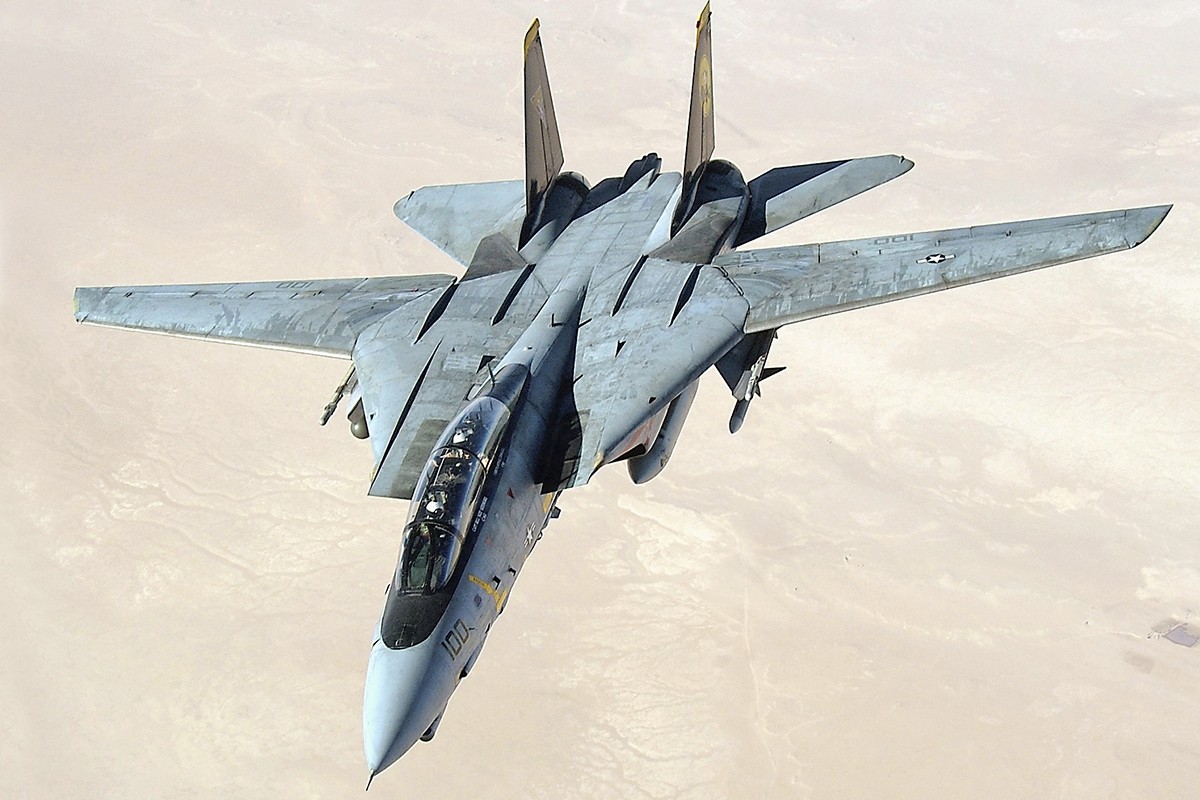 fighter jet flying over desert in the Persian Gulf region, showcasing the power and precision of an F-14D Tomcat