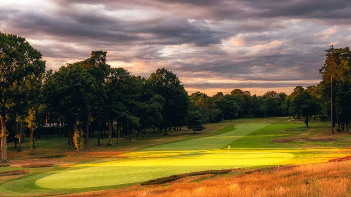 A golfer contemplating a shot on a links course, showcasing the strategic thinking required to navigate the challenging terrain and conditions