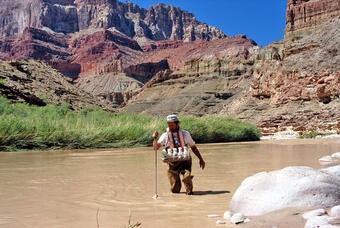 Hydrologist sampling sediment and turbidity in the Little Colorado River, Grand Canyon, demonstrating field measurements of turbidity.